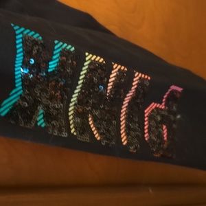 Victoria 's. Secret leggings with the word pink on one leg and cropped phone poc